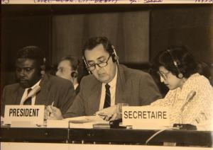 Foto mostra Gilberto Saboia, no centro da imagem, atuando enquanto presidente do comitê responsável pela redação da Declaração da Conferência Mundial de Direitos Humanos, que foi realizada em Viena, Áustria em junho de 1993. À sua esquerda, está Mochtar Cissé, assistente da secretária do comitê, e à direita de Saboia, está a diplomata indiana Tota Mukherjee, secretária do Comitê de Redação da Declaração da Conferência de Viena.